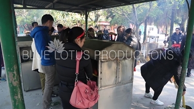 People Lighting Incense at a Stove at Po Lin Monastery on Lantau Island