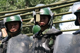 Chinese People's Armed Police Force/PAP (Zhongguo Renmin Wuzhuang Jingcha Budui/Wujing) Officers in a Personnel Transport Vehicle in Urumqi