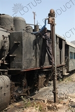 Engineer Filling a Vintage Steam Engine with Water on the Asmara to Massawa Railway