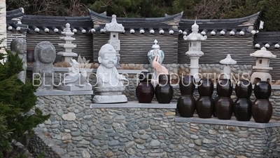 Pots and Statues in the 'Lucky Coin Divination' Area of Haedong Yonggung Temple (Haedong Yonggungsa) in Busan