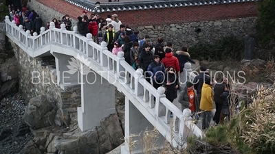 People on the Half Moon Bridge at Haedong Yonggung Temple (Haedong Yonggungsa) in Busan