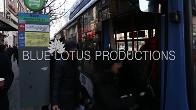 Passengers Boarding a Bus in Seoul