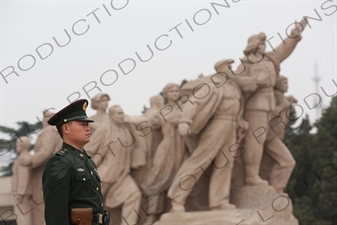 Soldier in front of a 'Heroes of the Revolution' Sculpture outside the Chairman Mao Memorial Hall/Mao's Mausoleum (Mao Zhuxi Jinnian Tang) in Tiananmen Square in Beijing