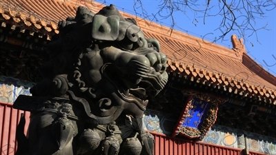 Guardian Lion Statue and Gate of Peace and Harmony (Yonghe Men) in the Lama Temple in Beijing