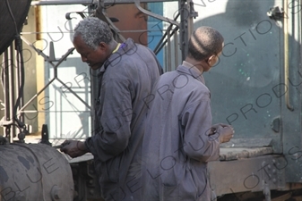 Driver and Engineer Inspecting a Vintage Steam Engine Going from Asmara to Massawa