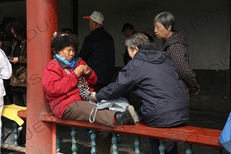 Woman Knitting in the Long Corridor (Chang Lang) in the Temple of Heaven (Tiantan) in Beijing
