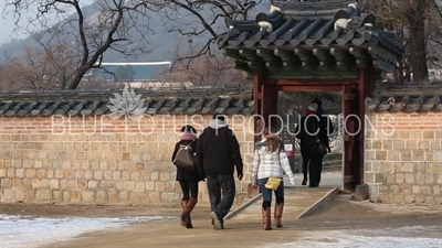 Tourists Walking through a Small Gate at Gyeongbok Palace (Gyeongbokgung) in Seoul