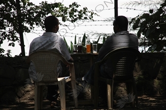 Men Drinking Sodas by Lake Tana