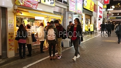 People Standing Outside a Small Restaurant in Shibuya Area of Tokyo