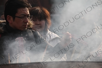 People Burning Incense in the Lama Temple (Yonghegong) in Beijing