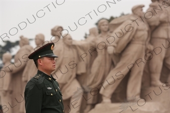 Soldier in front of a 'Heroes of the Revolution' Sculpture outside the Chairman Mao Memorial Hall/Mao's Mausoleum (Mao Zhuxi Jinnian Tang) in Tiananmen Square in Beijing