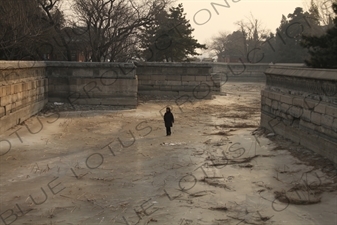 Woman Walking on a Frozen Kunming Lake in the Summer Palace in Beijing